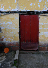 red door and yellow wall with faded paint