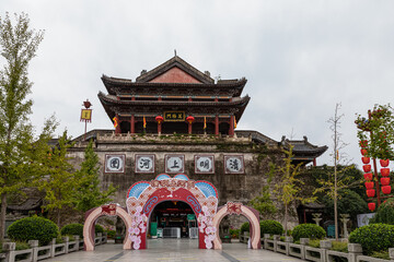 Entrance gate to Riverside Scene at Pure Moon Festival, one of Hengdian World Studios in Dongyang, Jinhua, Zhejiang, China. Recreation of famous 11th-CE Song dynasty painting ".