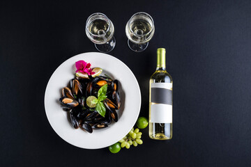 Bottle of wine lying down in black background with some food as decoration