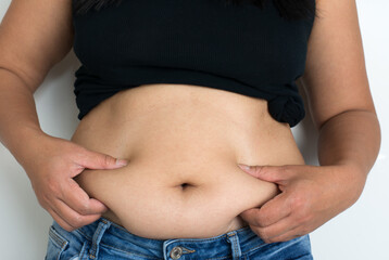 A woman holding fat folds  from her big belly, overweight body shape