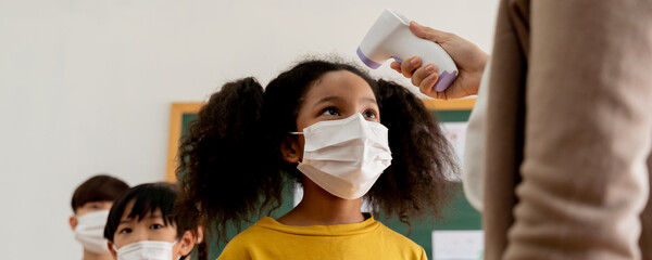 Banner group of diverse students in school building checked and scanned for temperature check....