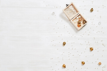 Metallic golden balls in small wooden open box, Christmas bauble scattered, Winter Holiday concept.