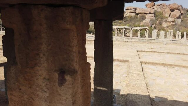Tracking Shot Through Colonnades of Ruined Temple at Hampi Archaeological Site, Hampe, Karnataka, India