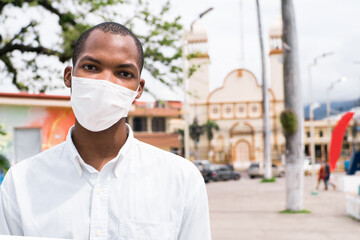 Young African American man in the street wearing a white mask,coronavirus concept.