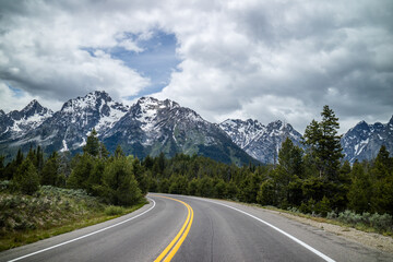 Fototapeta na wymiar A long way down the road going to Grand Tetons NP, Wyoming