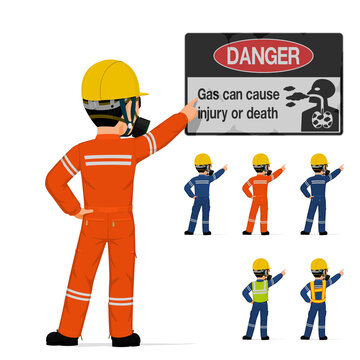 Isolated industrial worker with respirator is pointing to warning sign