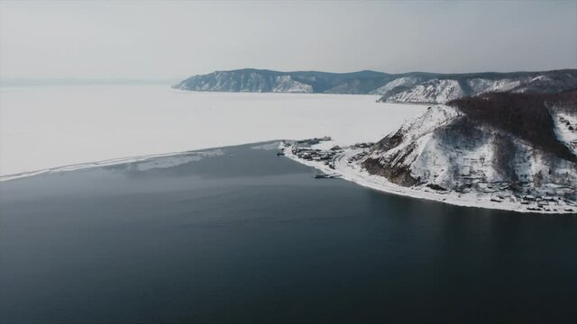Angara riverbed in winter aerial view of the confluence of Angara river with lake Baikal. High quality 4k footage