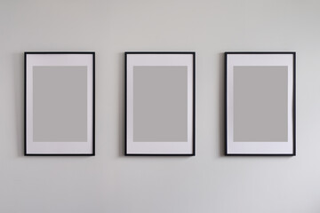Three blank frames on wall