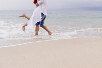 loving happy couple hugging on the Oceanside honeymoon. High quality photo
