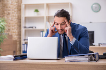 Young male businessman employee working in the office