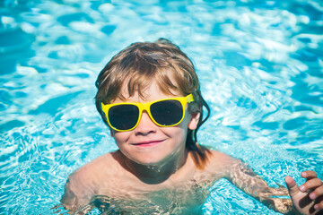 Portrait of cute kid having fun in swimming pool.