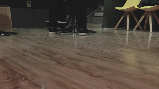 ground slide view of two mand working in a barber shop