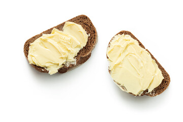 two pieces of bread with butter isolated white background