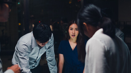 Millennial Asia businessmen and businesswomen meeting brainstorming ideas about new paperwork project colleagues working together planning success strategy enjoy teamwork in small modern night office.