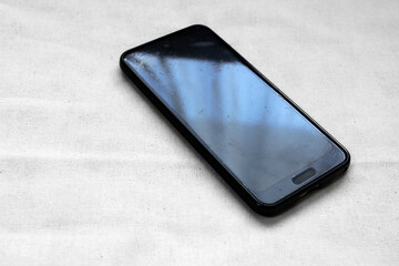 傷ついたスマートフォンの画面に映る窓