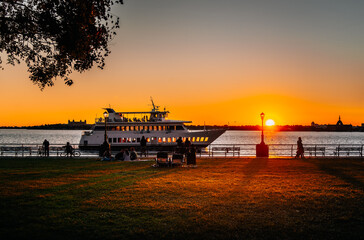 sunset in New York Manhattan  boat people sun colors orange beautiful 