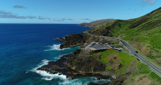4K backward tracking drone aerial view of the Halona Blowhole and tourists watching the blowhole on the eastern side of  the island of Oahu,Hawaii,USA
