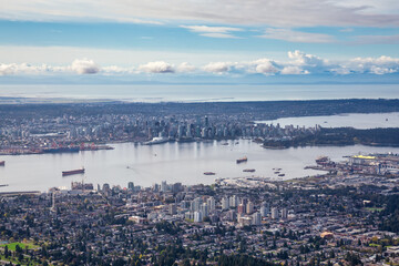 Aerial view of North Vancouver with Downtown City in the Background. Taken during sunny morning in British Columbia, Canada.