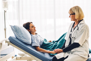 Obraz premium Woman doctor consulting and holding hand patient reassuring with care on bed in hospital.healthcare and medicine