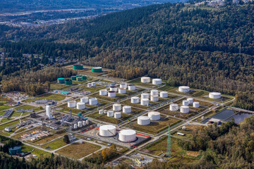 Aerial view of Oil Refinery Industrial Site in a modern city. White Holding Container Tanks. Taken...