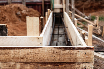 Timber formwork with metal reinforcement for pouring concrete and creating a solid foundation for a...