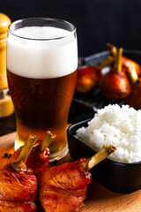 Pub menu. Glass of beer with foam, baked spicy chicken legs and hot boiled res