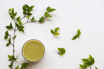 herbal healthy drinks hot green tea ,milks for health care with leaf arrangement flat lay style on background white 