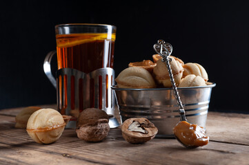  cookies nuts with caramel on an old wooden background