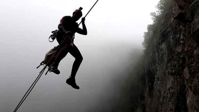 Descending a rappel in backlight in the hole of the Trou de Fer, one of the most famous canyons in the world.