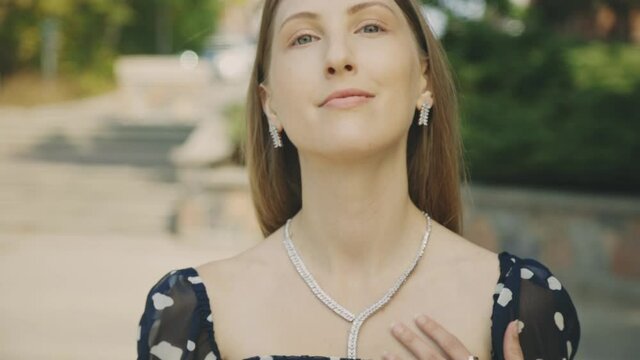 Charming Female Caucasian Model Wearing Printed Chiffon Tops And Elegant Jewelry Set Posing In Front Of The Camera - Rack Focus Slow Motion
