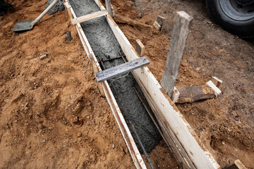 Timber formwork with metal reinforcement for pouring concrete and creating a solid foundation for a...