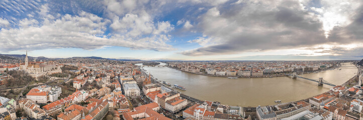 Naklejka na ściany i meble Aerial panoramic drone shot of Hungarian Parliament by Danube in Budapest winter morning