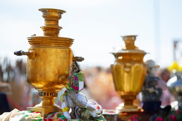 Golden samovars at the festive fair.