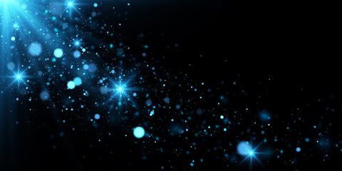 Abstract magical background with sparks and stars. Blue particles and glowing lights. Sparkling glittering effect on black.  