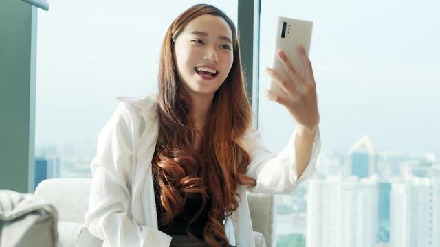 Happy young asian woman using mobile phone and selfie in the city  Bangkok, Thailand, Travel vacation city skyscrapers concept.