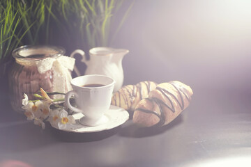 French breakfast on the table. Coffee croissant with chocolate and a decanter with cream. Fresh...