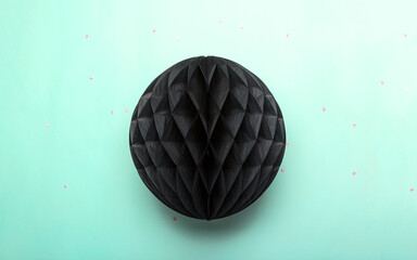 Paper lantern on pastel blue background. Black lampion - festive decorated for holiday.