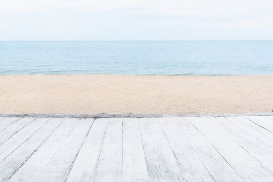 Beach background, Table top white wood with blurred tropical sea in summer