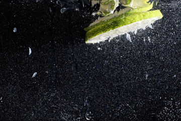 Water drops on ripe sweet lemon. Fresh lime  background with copy space for your text. Vegan concept.