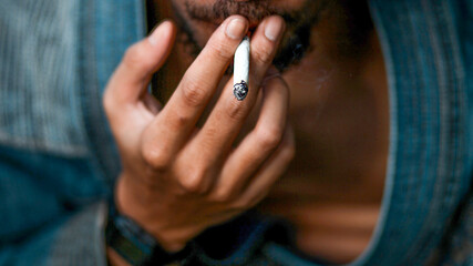 Close up of man hand smoking a cigarette.