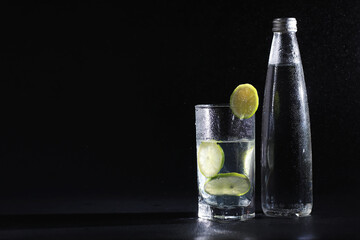 Lime water. Drinking water with fresh lime. Mineral water. Healthy, mineral-rich, refreshing water with lime.