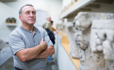 italian visitor is looking at the exposition in historical museum.