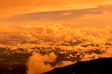 Beautiful landscape at sunset sky with clouds on peak of mountains.