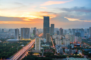 Naklejka na ściany i meble Hanoi skyline cityscape during sunset period at Pham Hung street in Cau Giay district in 2020