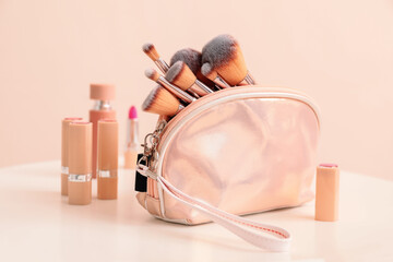 Set of makeup brushes with decorative cosmetics on table