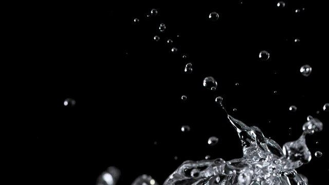 Water splashing on black background, super slow motion. Filmed on high speed cinema camera, 1000 fps.