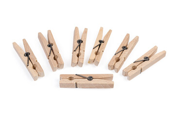 New wooden clothespins on a white background