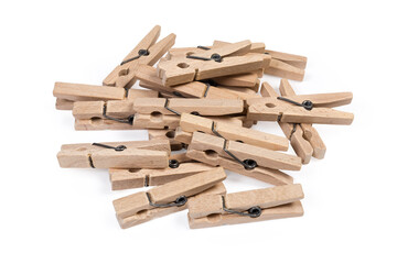Pile of wooden clothespins on a white background close-up