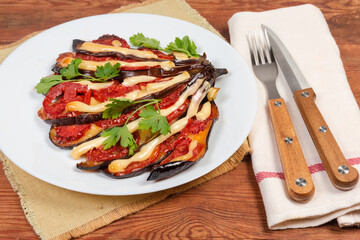 Serving baked eggplant stuffed with tomatoes and cheese close-up