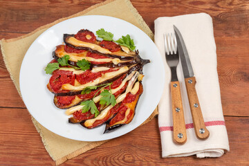 Serving of baked eggplant stuffed with tomatoes and cheese